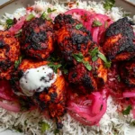 Chicken Tandoori with Cilantro Rice piled with charred tandoori-style chicken thighs, bright pickled red onions, fresh cilantro, and a creamy yogurt dollop.