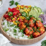 Fiesta Lime Shrimp Bowl with chili-lime shrimp, white rice, avocado, corn salsa, tomatoes, jalapeños, red onion, fresh cilantro, and lime wedges.