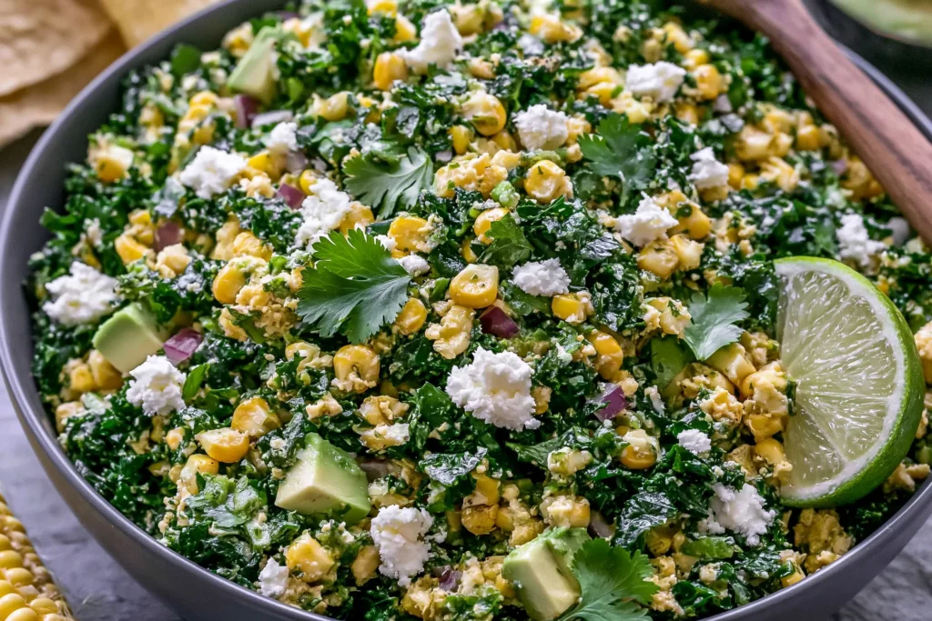 Mexican Street Corn Kale Salad with grilled corn, tender kale, creamy avocado, cotija cheese, fresh cilantro, red onion, and a zesty cilantro lime dressing.