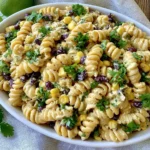 Black Bean & Corn Pasta Salad with rotini pasta, black beans, sweet corn, fresh cilantro, and a creamy Greek yogurt lime dressing in a serving bowl.