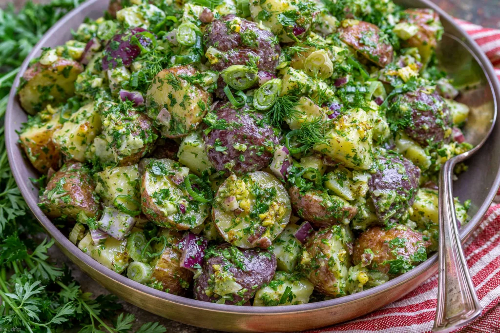 French Potato Salad made with baby red potatoes, fresh parsley, dill, green onions, and Dijon mustard tossed in a light herb vinaigrette.