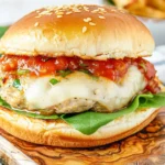 Italian Chicken Burgers with melted mozzarella, marinara sauce, and fresh arugula served on a toasted sesame seed bun