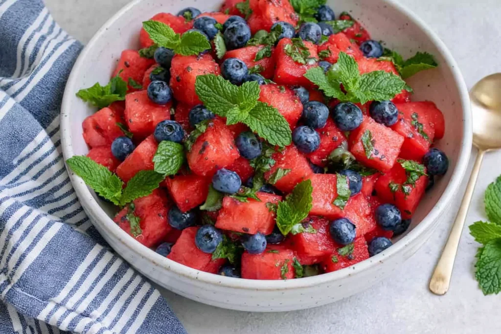 Watermelon Blueberry Salad made with juicy watermelon, fresh blueberries, chopped mint, and honey lime dressing in a serving bowl.