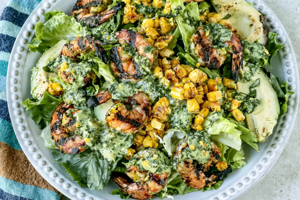 Grilled Shrimp Summer Salad topped with grilled shrimp, charred corn, avocado slices, romaine lettuce, and creamy homemade green goddess dressing.