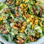 Grilled Shrimp Summer Salad topped with grilled shrimp, charred corn, avocado slices, romaine lettuce, and creamy homemade green goddess dressing.